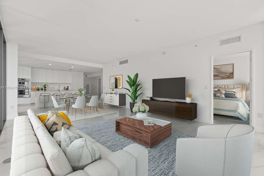 700 Northeast 24th Street, Unit 4907 Miami, FL 33137 - Photo 4 of 47 a living room with furniture and a flat screen tv