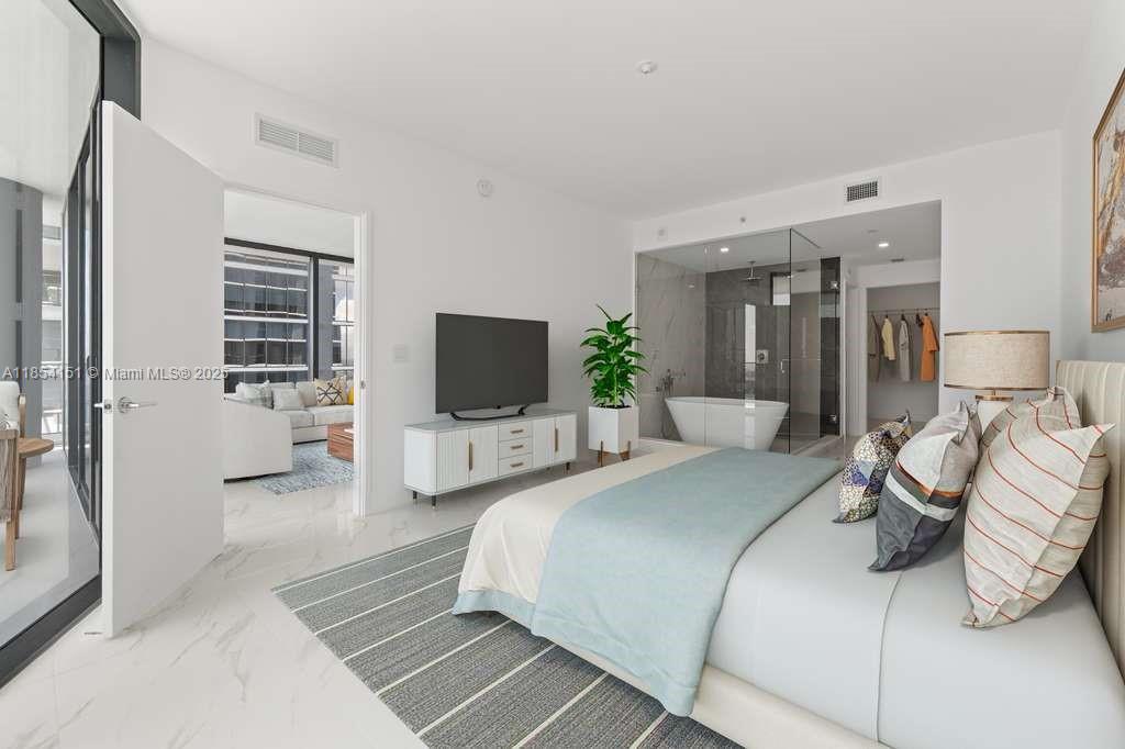 700 Northeast 24th Street, Unit 4907 Miami, FL 33137 - Photo 5 of 47 a bedroom with a bed and a flat screen tv