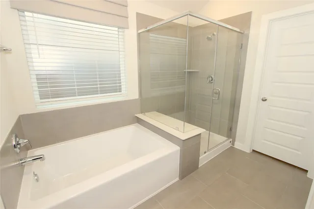 a bathroom with a tub a sink and a shower