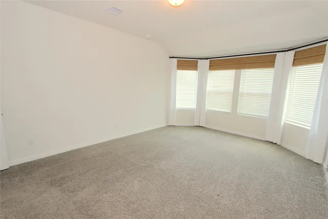 an empty room with windows and closet