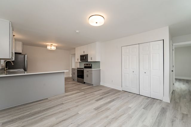 a view of kitchen with wooden floor