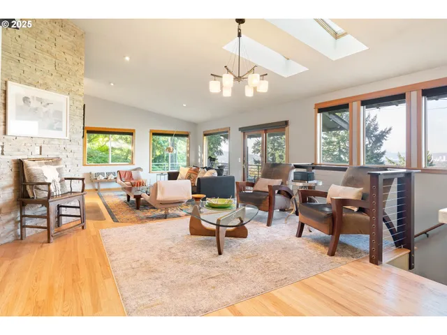 a living room with furniture dining table and a large window