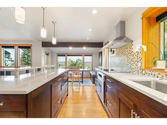 a large kitchen with lots of counter space a sink and a window