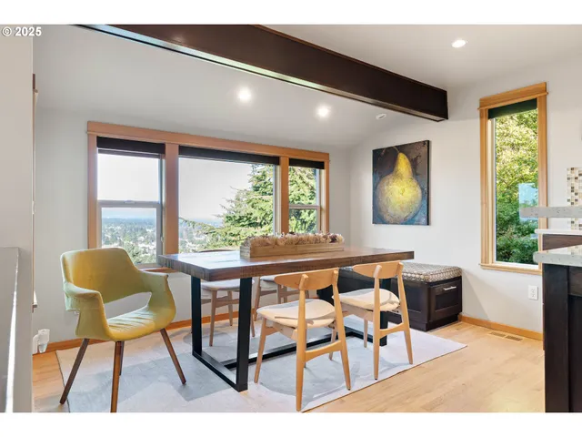 a dining room with furniture and a window