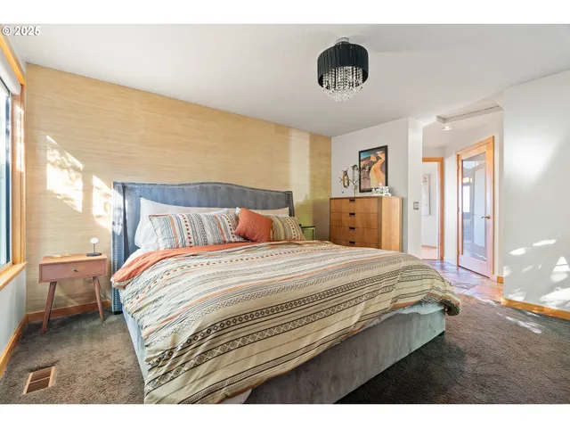 a bedroom with a bed and a large window