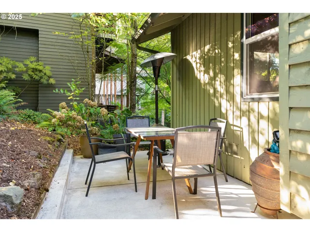 a view of a patio with table and chairs and potted plants