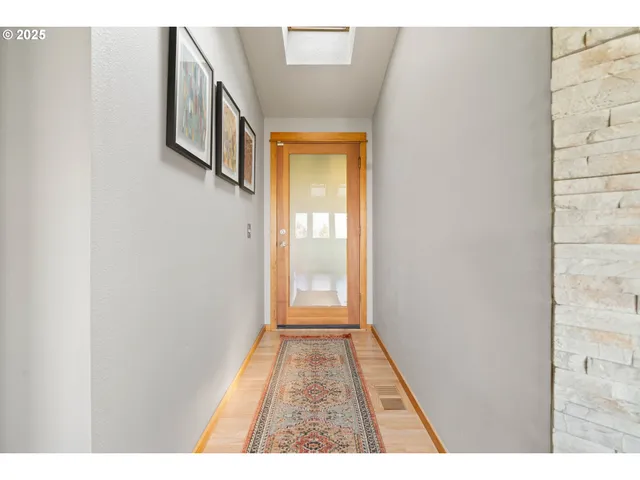a view of a hallway with wooden floor