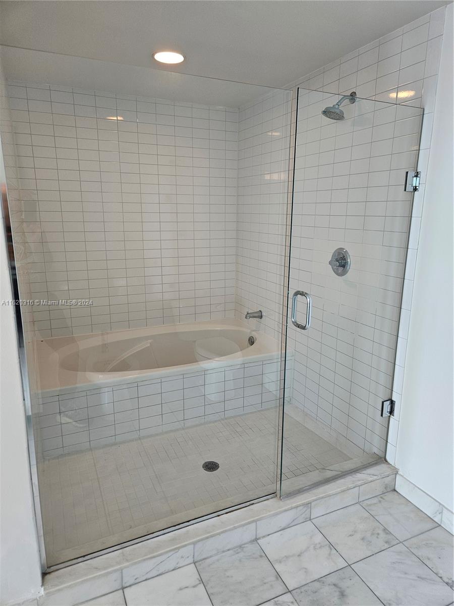 888 Biscayne Boulevard, Unit 2701 Miami, FL 33132 - Photo 11 of 37 a bathroom with a shower