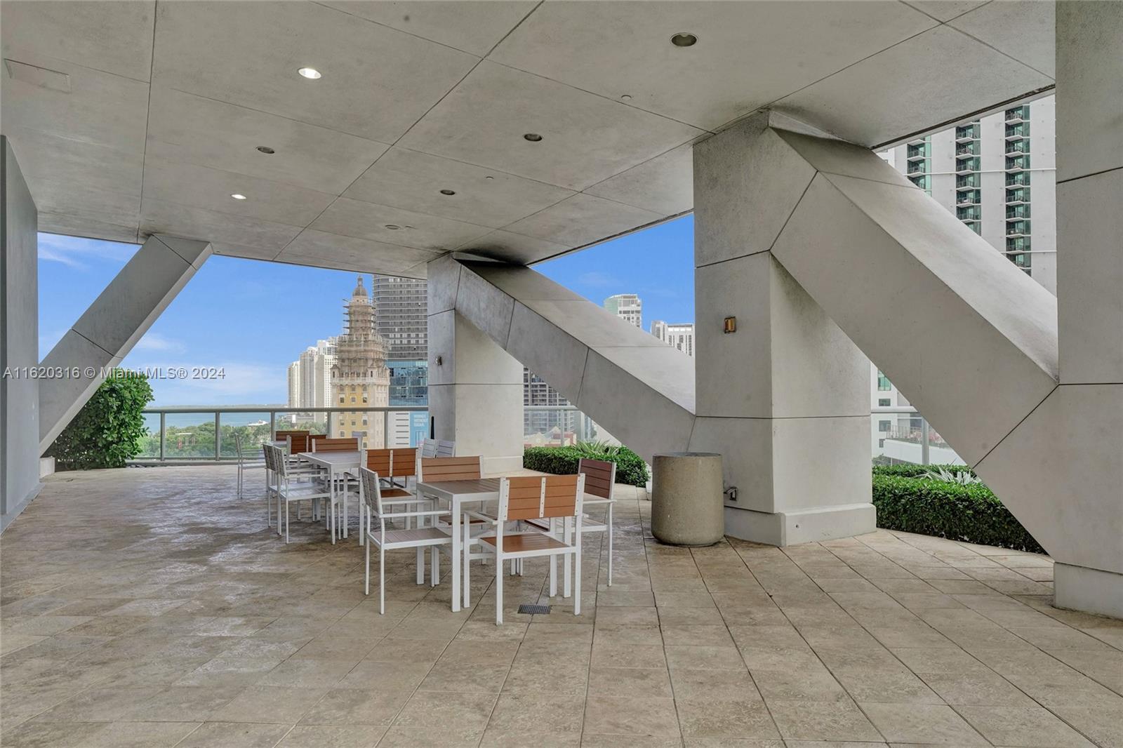 888 Biscayne Boulevard, Unit 2701 Miami, FL 33132 - Photo 25 of 37 a view of a patio with table and chairs