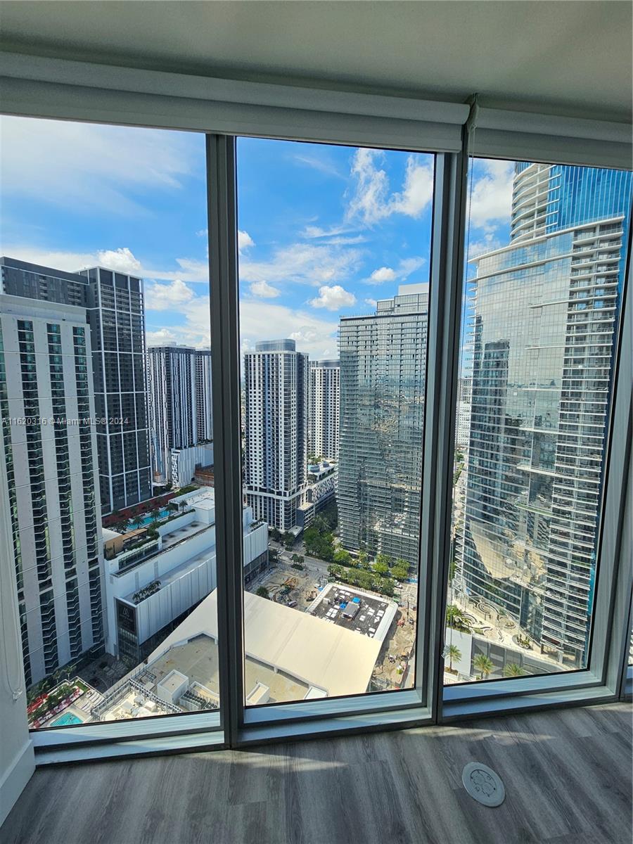 888 Biscayne Boulevard, Unit 2701 Miami, FL 33132 - Photo 31 of 37 a view of a living room with a floor to ceiling window