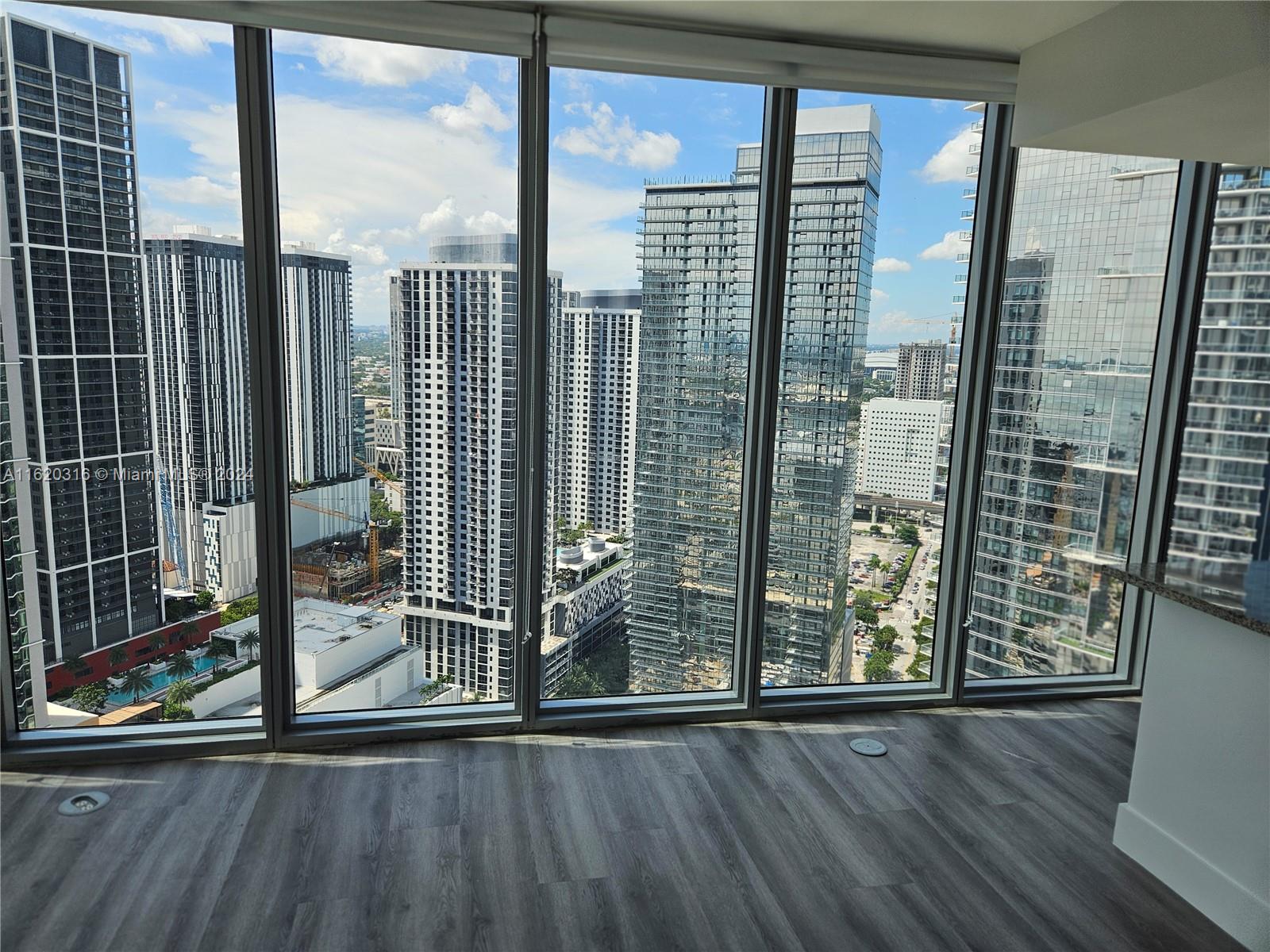 888 Biscayne Boulevard, Unit 2701 Miami, FL 33132 - Photo 6 of 37 a view of a city from a living room