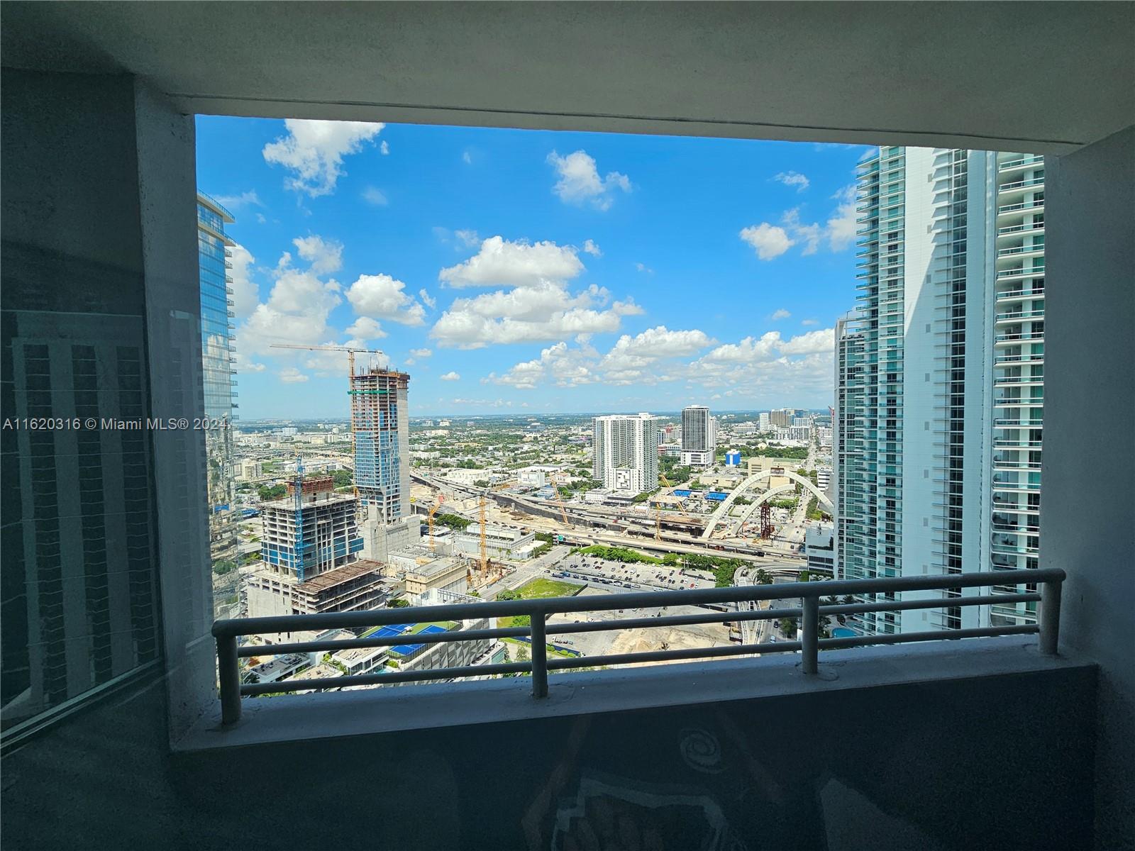 888 Biscayne Boulevard, Unit 2701 Miami, FL 33132 - Photo 7 of 37 a view of a balcony with furniture