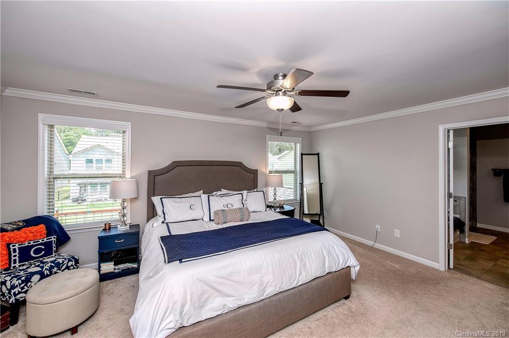 2262 Bluebell Way Tega Cay, SC 29708 - Photo 22 of 34 a bedroom with a bed a couch and a window