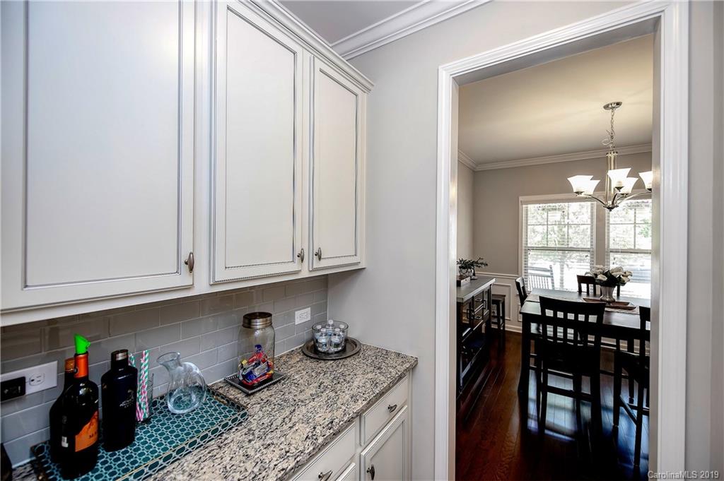 2262 Bluebell Way Tega Cay, SC 29708 - Photo 8 of 34 a kitchen with granite countertop lots of white cabinets stainless steel appliances and cabinets