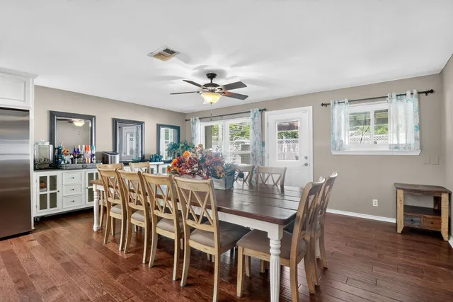 a living room with stainless steel appliances kitchen island furniture and a view of kitchen
