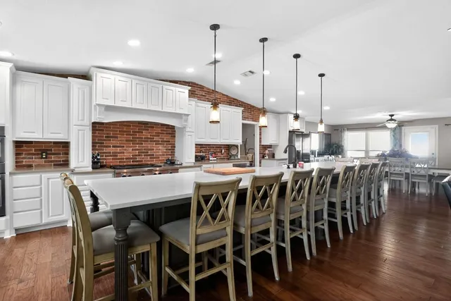 a large kitchen with a table and chairs