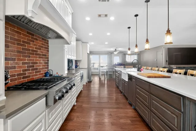 a kitchen with counter top space and wooden floor