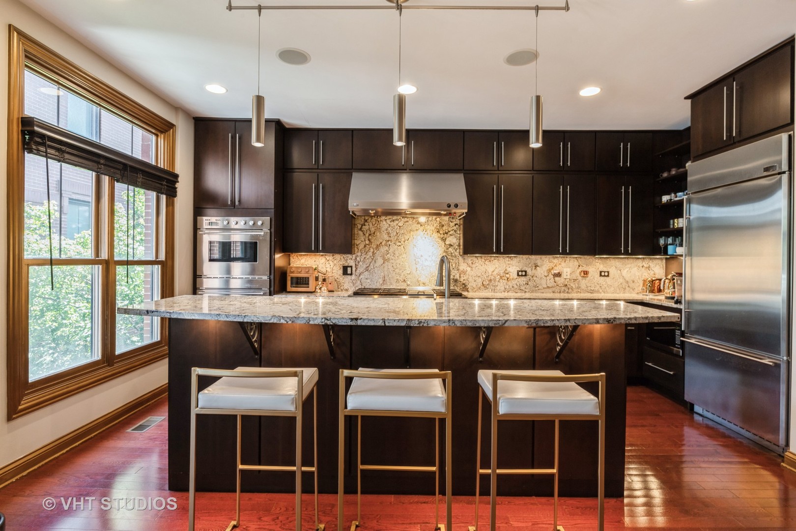 1867 Admiral Court Glenview, IL 60026 - Photo 6 of 28 a kitchen with granite countertop a table chairs stainless steel appliances and cabinets