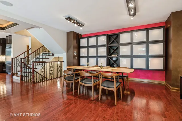 a dining room with wooden floor a glass table and chairs