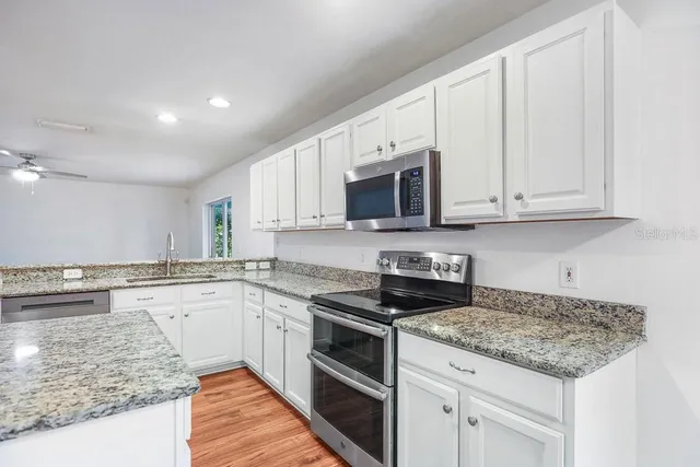 a kitchen with granite countertop white cabinets and a granite counter tops