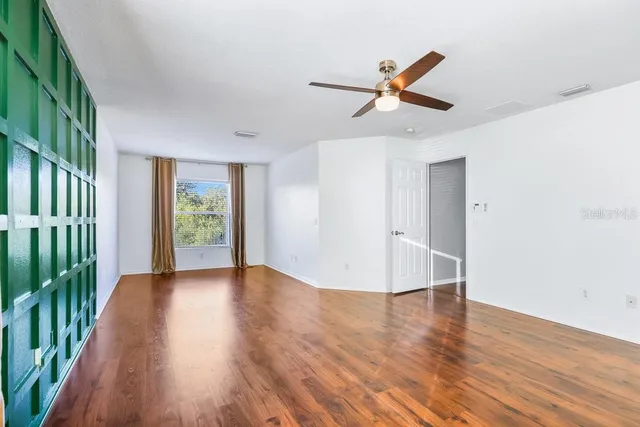 wooden floor in an empty room with a window