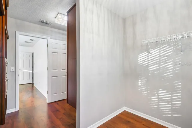 a view of bedroom with wooden floor and windows