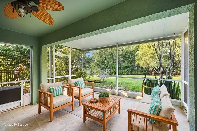a view of a porch with furniture and floor to ceiling window