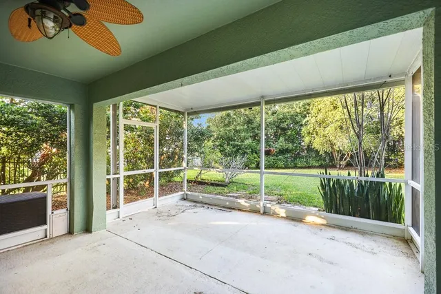 an empty room with sliding glass door and mountain view