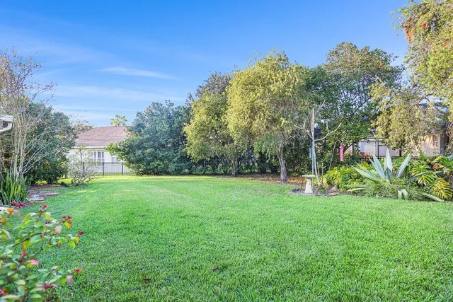 a view of backyard of house with green space