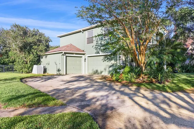 a front view of a building with a garden