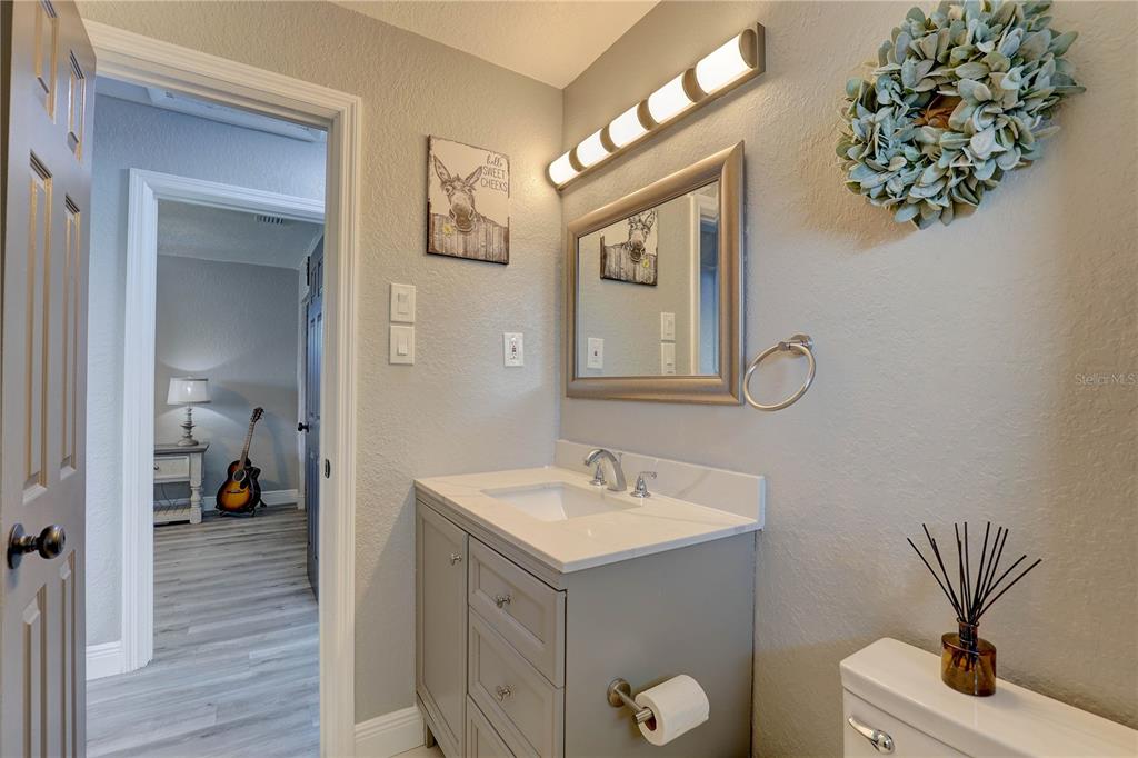 8201 Ridge Road Seminole, FL 33772 - Photo 12 of 36 a en suite bathroom with a toilet sink and mirror