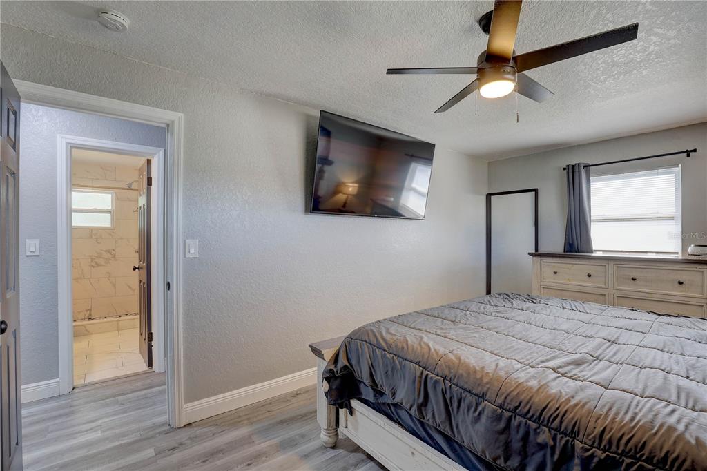 8201 Ridge Road Seminole, FL 33772 - Photo 13 of 36 a bedroom with a bed and a flat screen tv