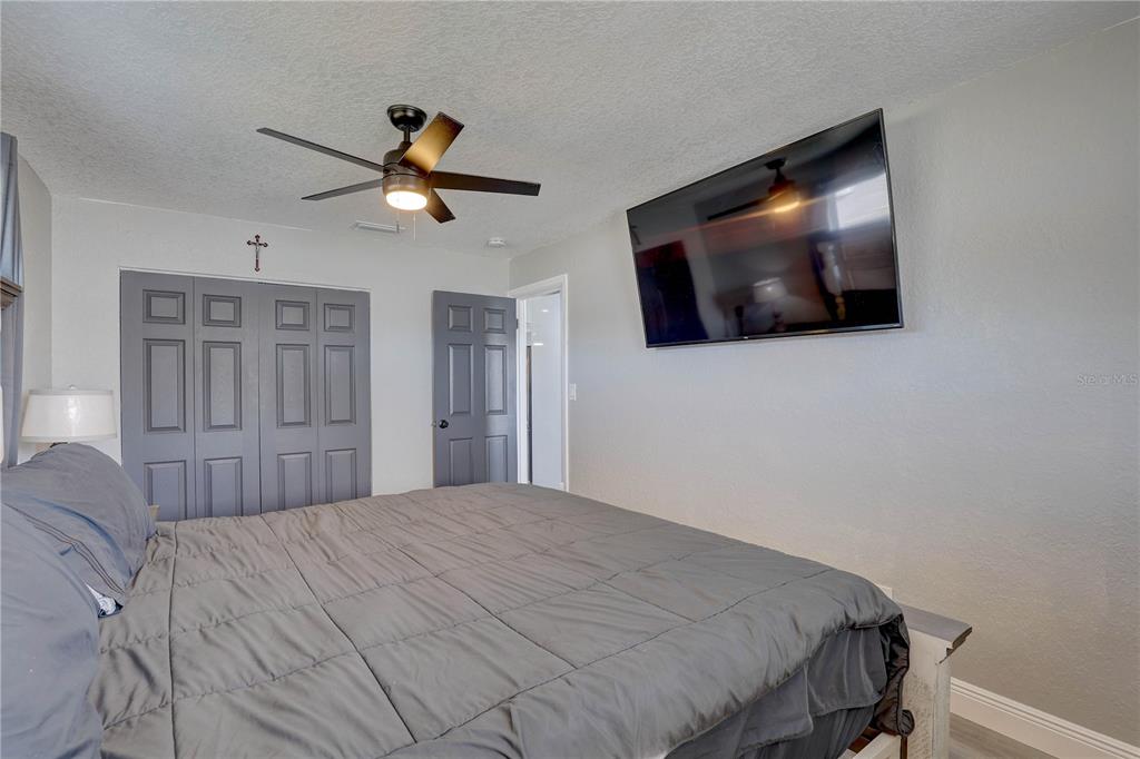 8201 Ridge Road Seminole, FL 33772 - Photo 15 of 36 a bedroom with a bed and a flat screen tv