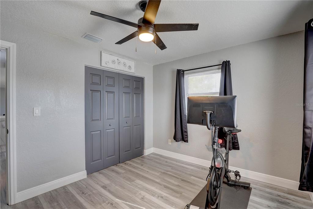 8201 Ridge Road Seminole, FL 33772 - Photo 18 of 36 a room that has a bed and a chandelier fan