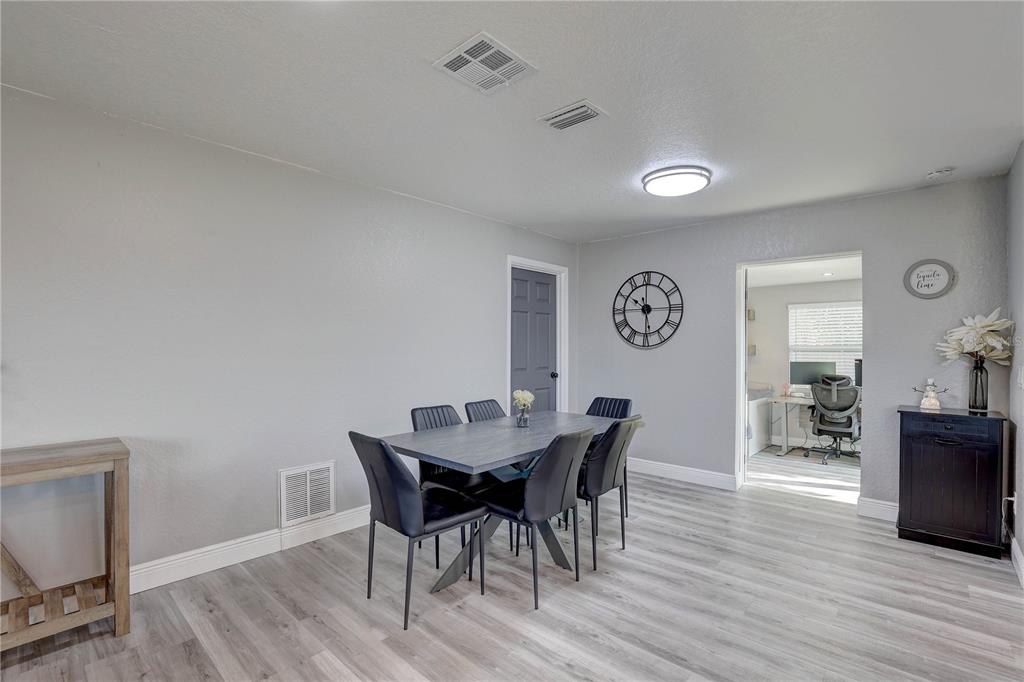 8201 Ridge Road Seminole, FL 33772 - Photo 19 of 36 a view of a dining room with furniture and wooden floor