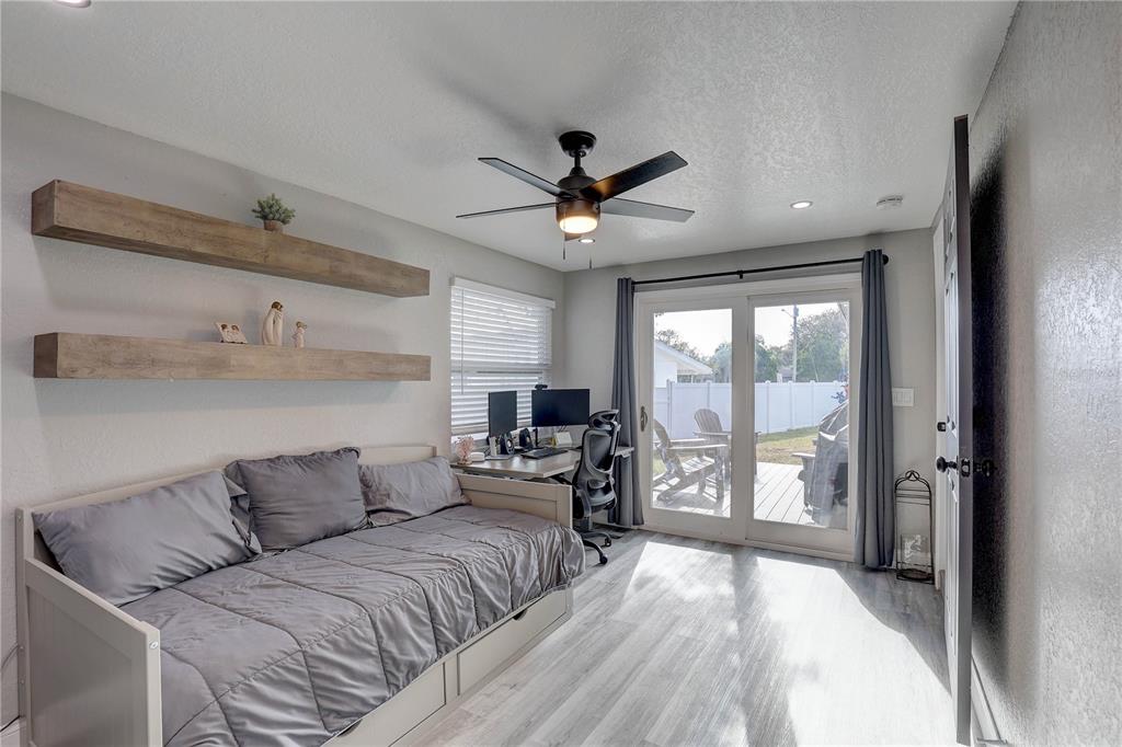 8201 Ridge Road Seminole, FL 33772 - Photo 23 of 36 a living room with furniture large window and flat screen tv