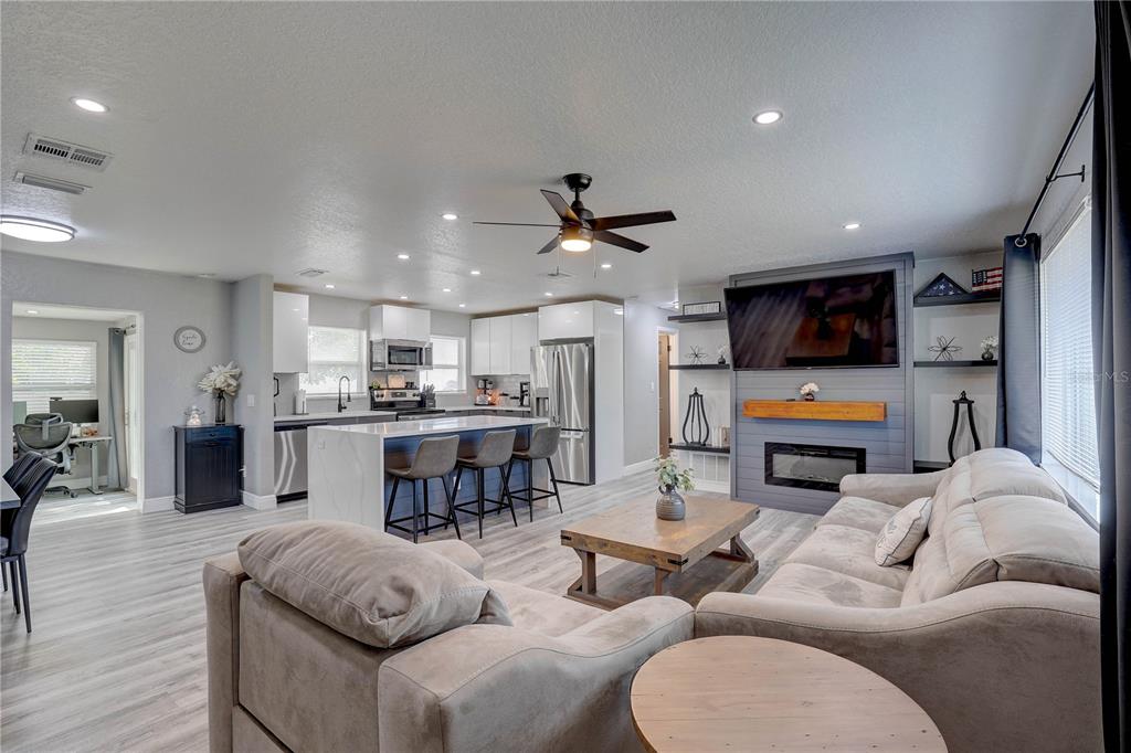 8201 Ridge Road Seminole, FL 33772 - Photo 3 of 36 a living room with furniture kitchen view and a wooden floor