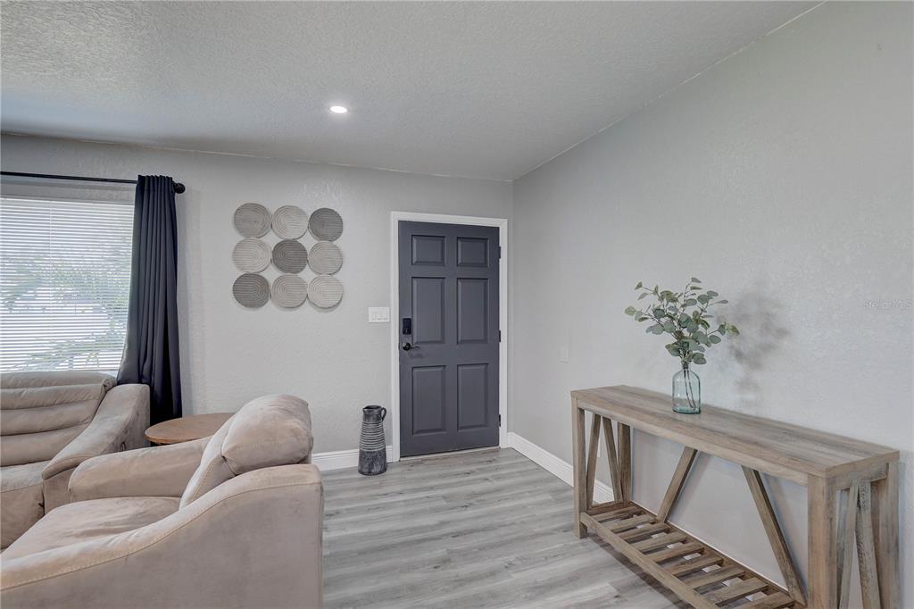 8201 Ridge Road Seminole, FL 33772 - Photo 31 of 36 a living room with furniture and a potted plant