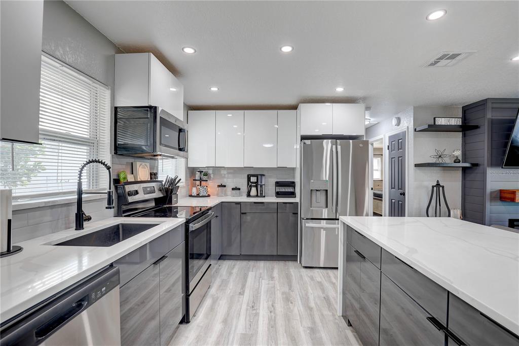 8201 Ridge Road Seminole, FL 33772 - Photo 5 of 36 a kitchen with refrigerator a sink and cabinets