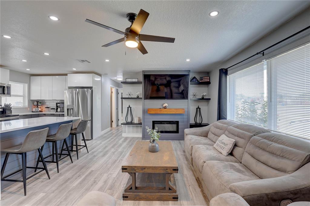 8201 Ridge Road Seminole, FL 33772 - Photo 8 of 36 a living room with furniture kitchen area and a large window