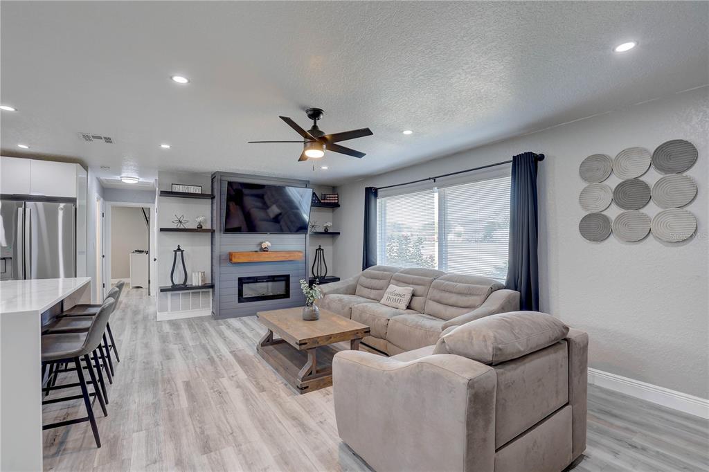8201 Ridge Road Seminole, FL 33772 - Photo 9 of 36 a living room with furniture and a fireplace