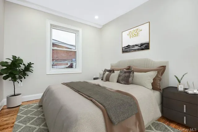 a bedroom with a bed and a potted plant