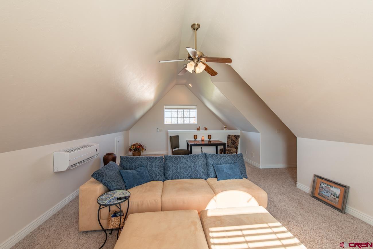 68020 Tumbleweed Road Montrose, CO 81403 - Photo 16 of 45 a living room with furniture and a chandelier