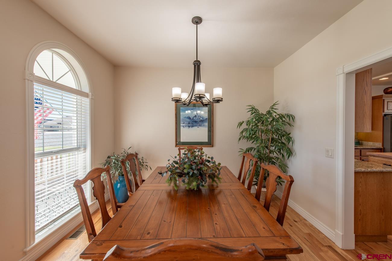 68020 Tumbleweed Road Montrose, CO 81403 - Photo 24 of 45 a view of a dining room with furniture window and wooden floor