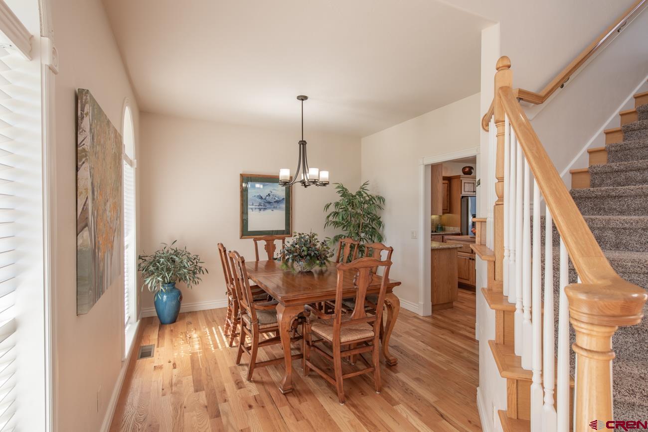 68020 Tumbleweed Road Montrose, CO 81403 - Photo 26 of 45 a view of a dining room with furniture window and wooden floor