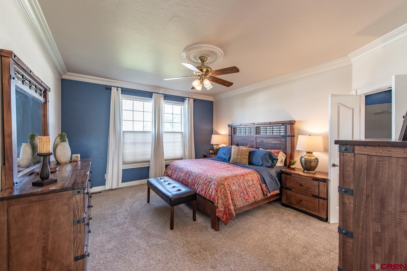 68020 Tumbleweed Road Montrose, CO 81403 - Photo 27 of 45 a bedroom with a bed and furniture