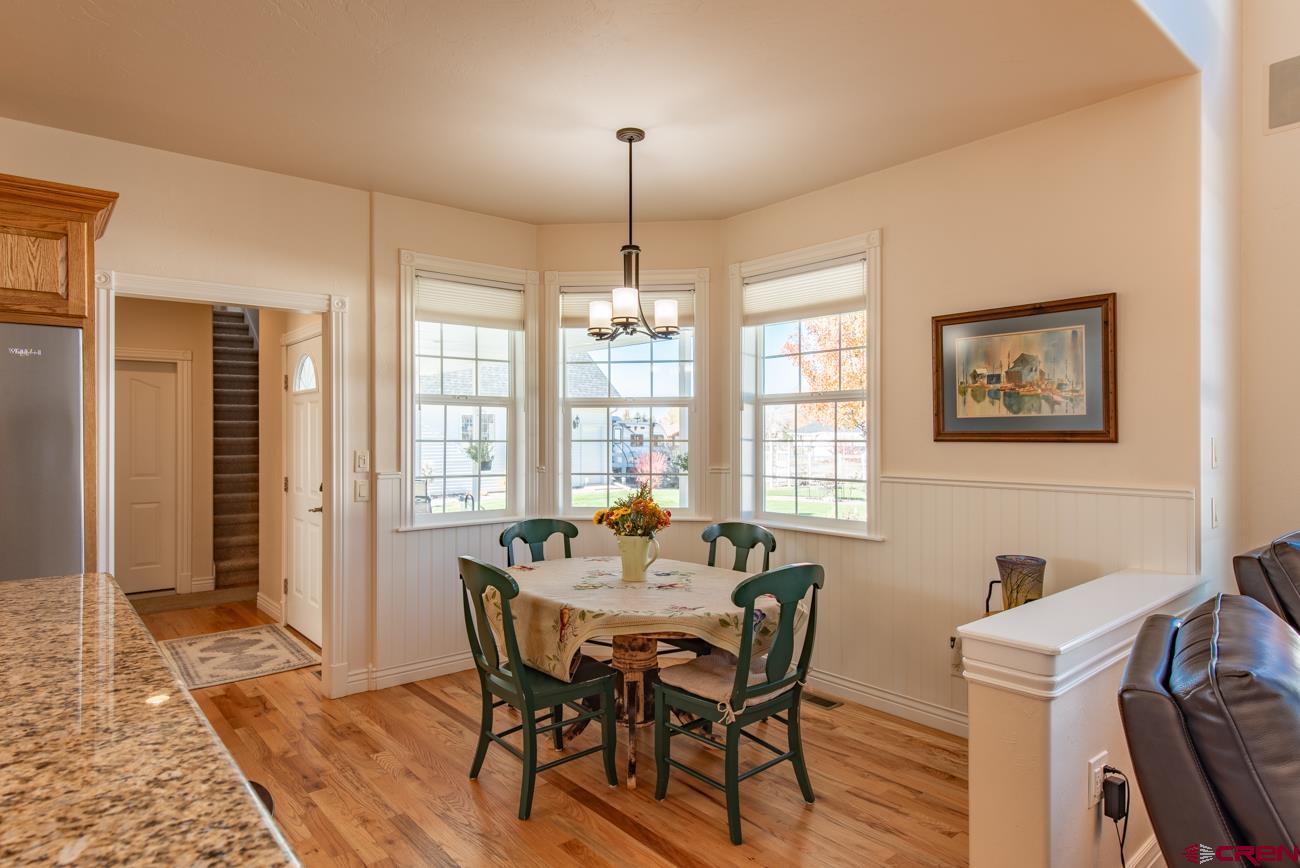 68020 Tumbleweed Road Montrose, CO 81403 - Photo 10 of 45 a dining room with furniture a chandelier and wooden floor