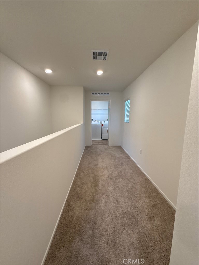 479 Hollyhock Circle San Jacinto, CA 92582 - Photo 15 of 36 a view of a big room with wooden floor and windows