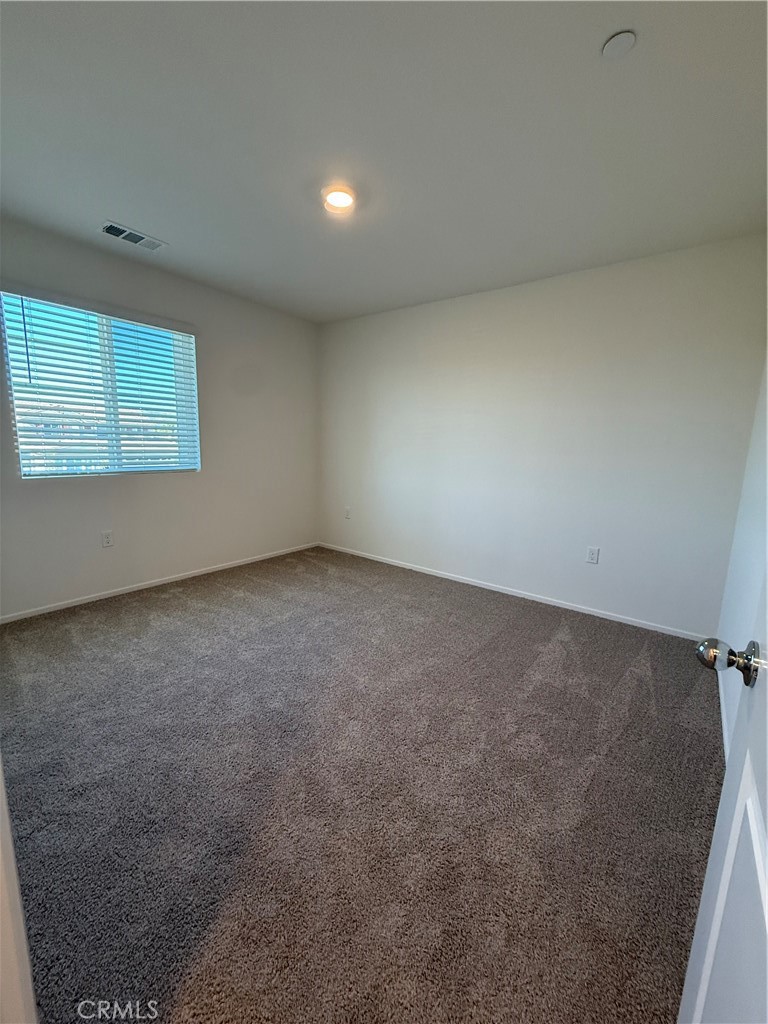 479 Hollyhock Circle San Jacinto, CA 92582 - Photo 18 of 36 an empty room with a empty space and window
