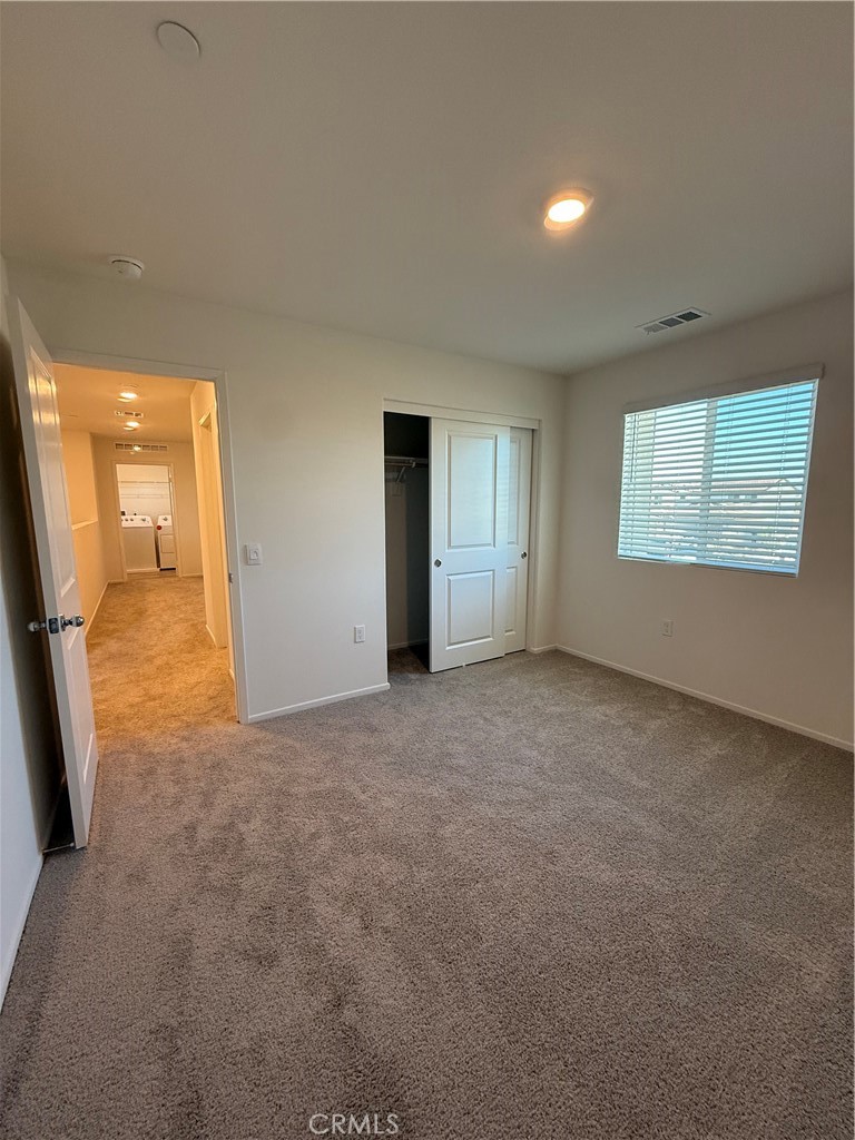 479 Hollyhock Circle San Jacinto, CA 92582 - Photo 19 of 36 an empty room with windows